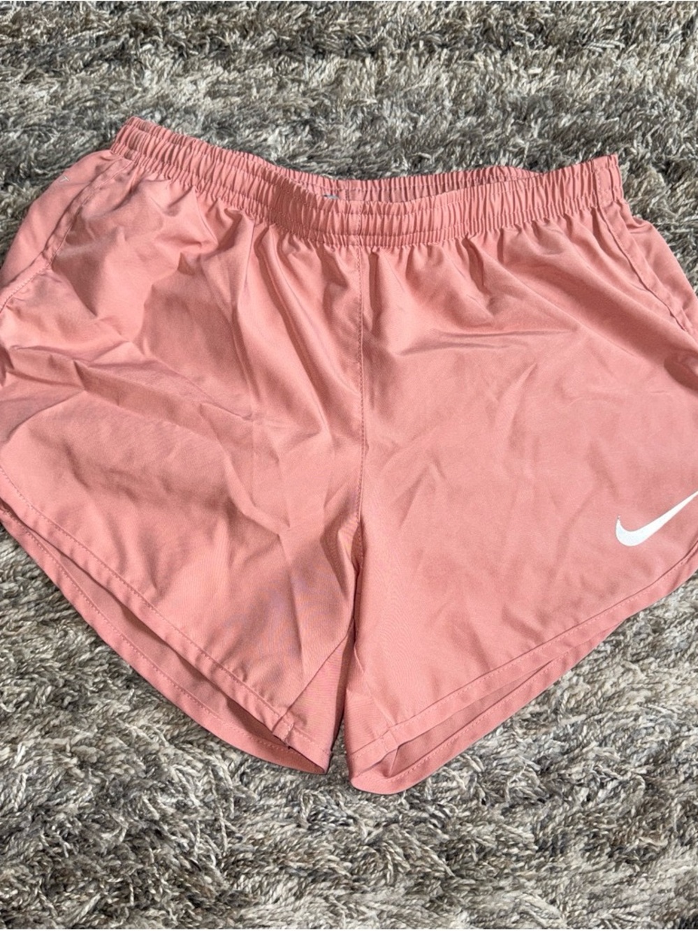 Nike Women's Coral-Style Pink Athletic Shorts with White Swoosh